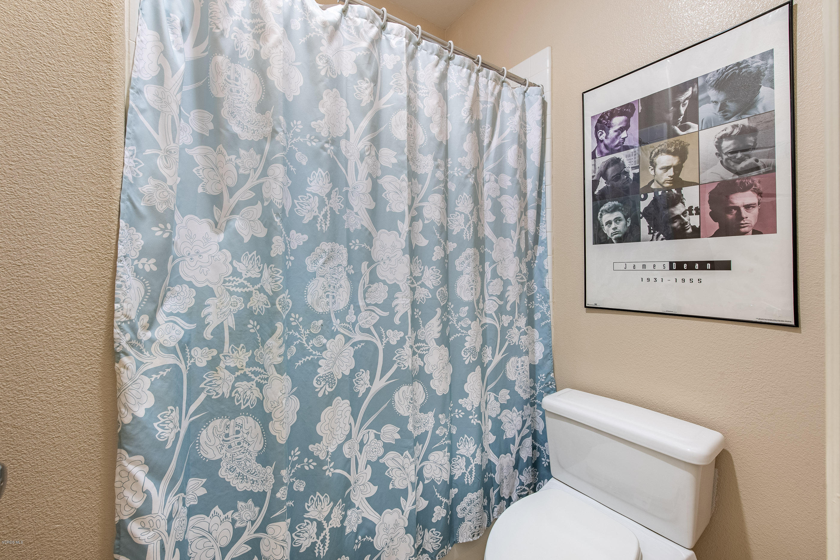 13625 Silver Oak Lane Moorpark, CA 93021 - Photo 28 of 35 a white toilet sitting next to a shower curtain