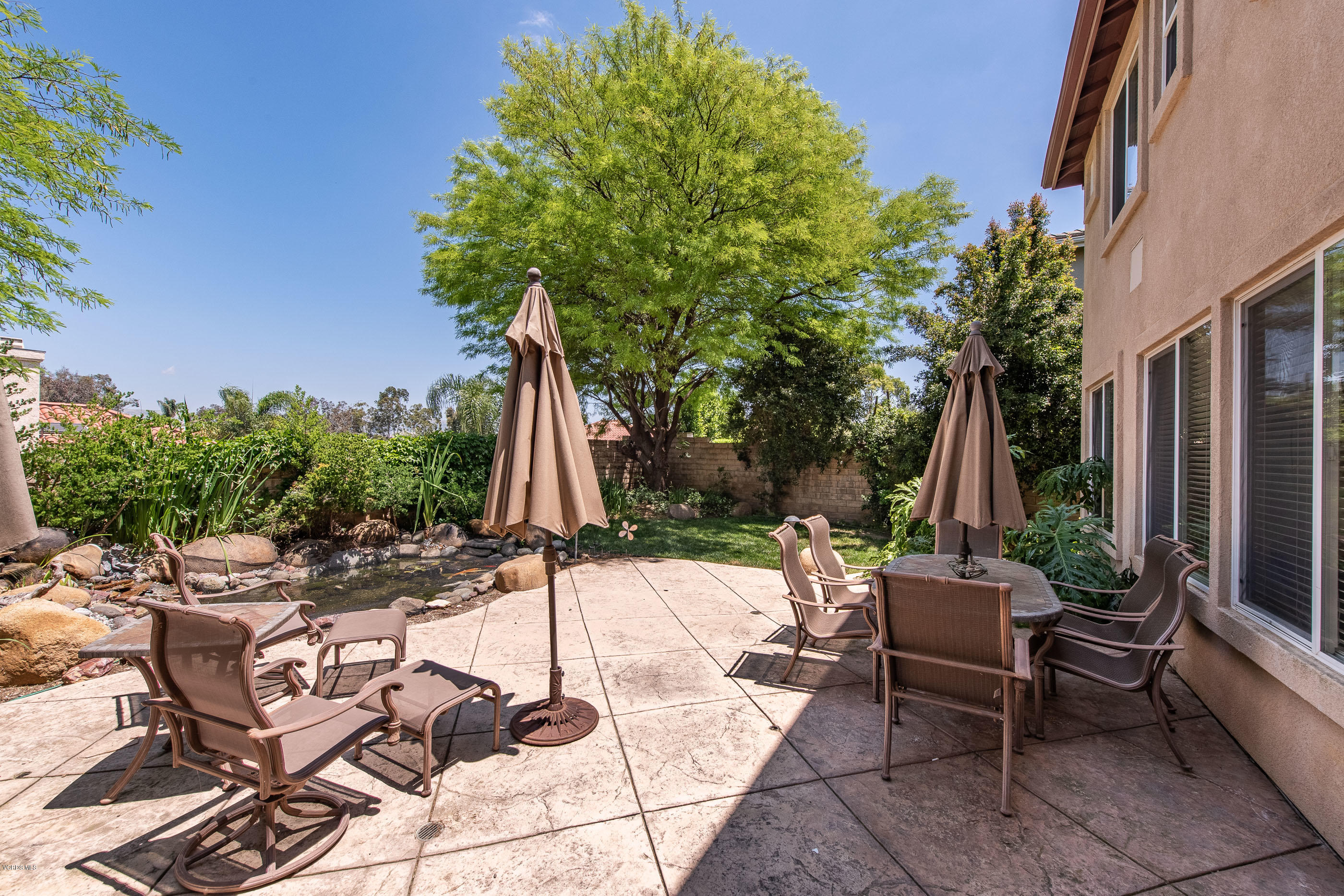 13625 Silver Oak Lane Moorpark, CA 93021 - Photo 35 of 35 a view of a patio with table and chairs potted plants and palm tree