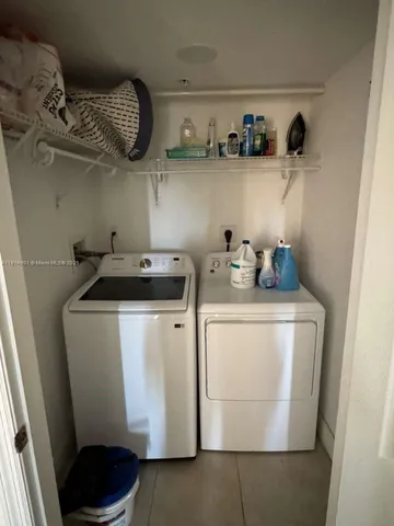 a utility room with sink dryer and washer