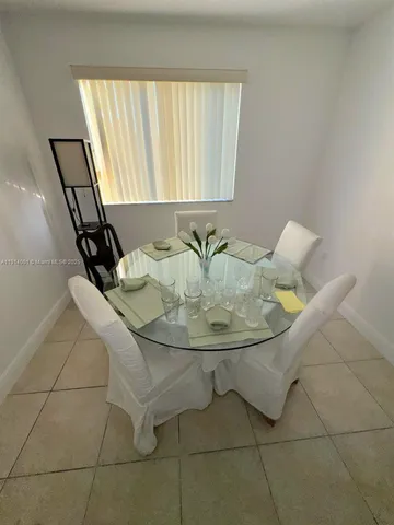 a view of dining room with granite countertop a couch and a mirror