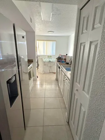 a living room with a sink a washer and dryer