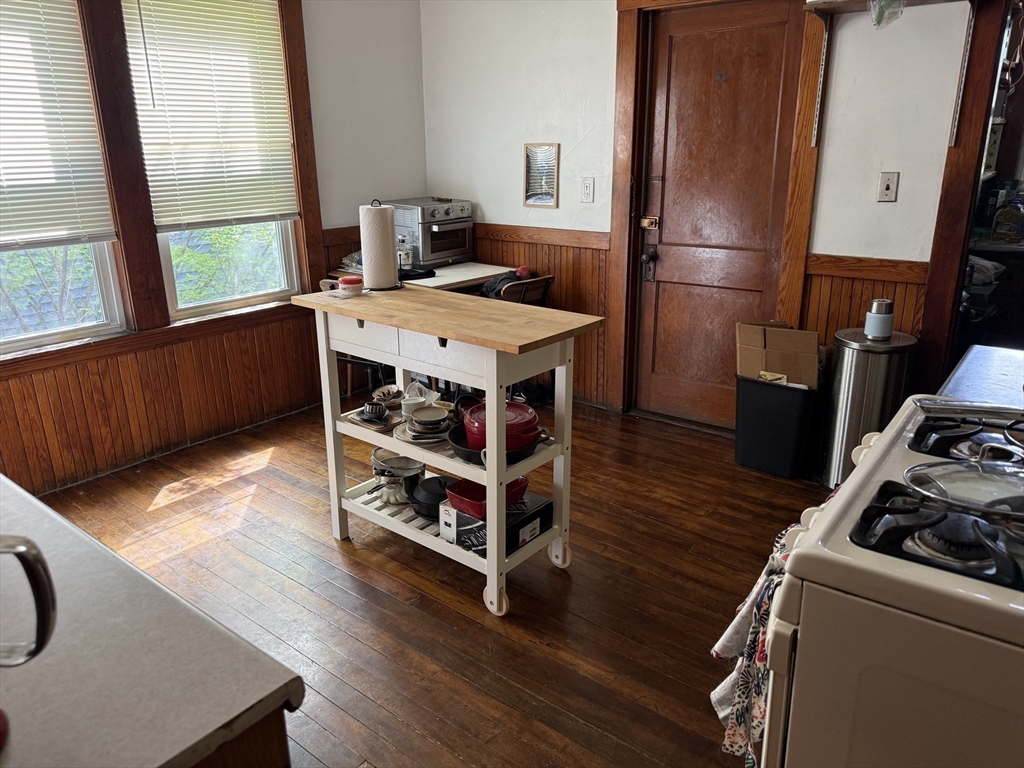 29 Lewis Street, Unit 1 Somerville, MA 02143 - Photo 3 of 16 a room with furniture and wooden floor