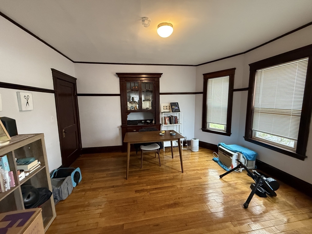 29 Lewis Street, Unit 1 Somerville, MA 02143 - Photo 6 of 16 a living room with furniture gym equipment and a flat screen tv