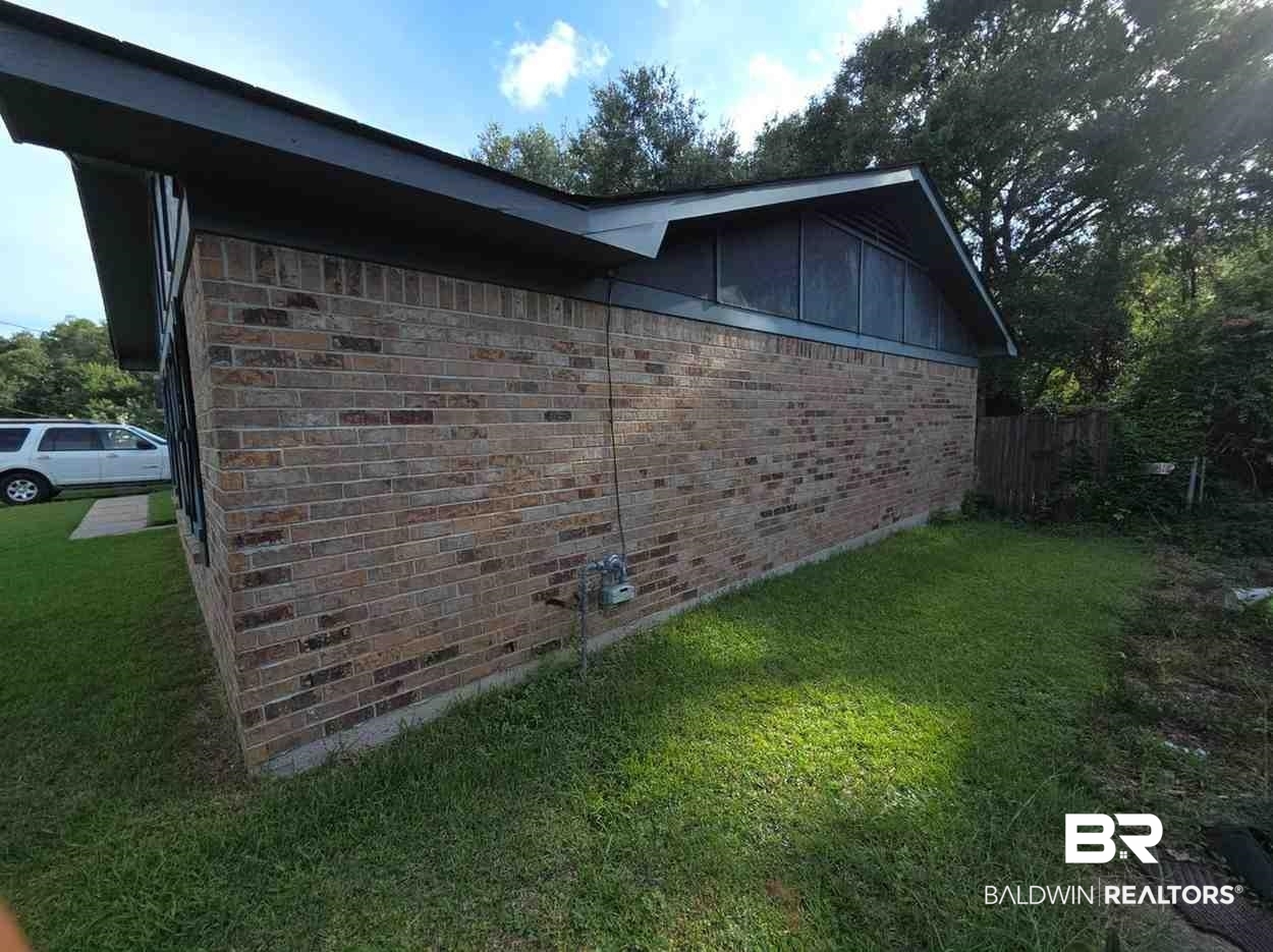 5120 West Celtic Drive Mobile, AL 36619 - Photo 2 of 27 View of side of home with brick siding
