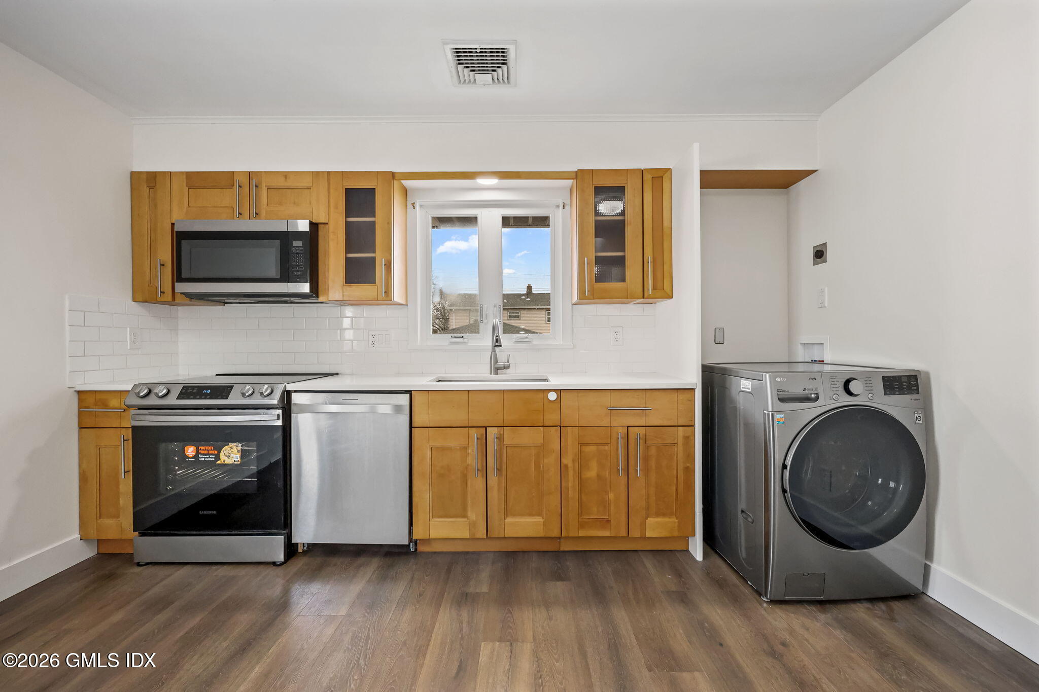 2 Grange Street Greenwich, CT 06830 - Photo 4 of 31 a kitchen with stainless steel appliances granite countertop a stove a sink and a microwave