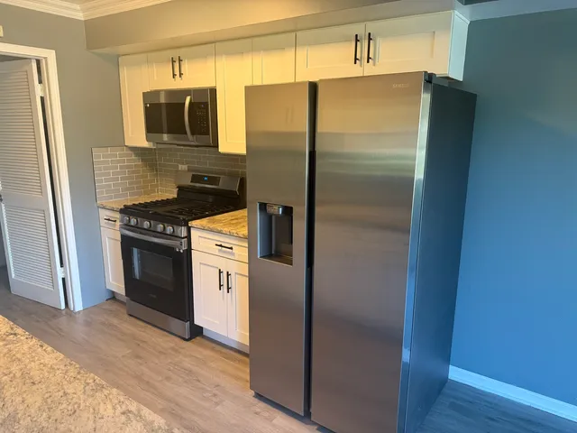 a kitchen with a refrigerator stove and microwave