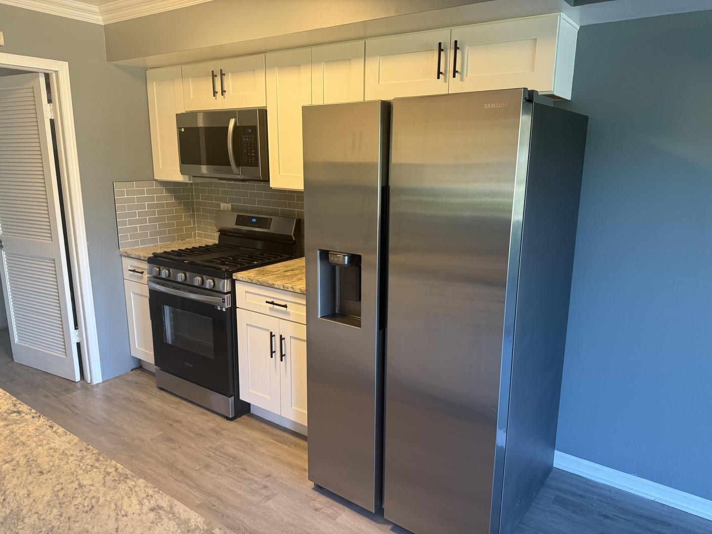 1319 Kingsbury Drive, Unit 2 Hanover Park, IL 60133 - Photo 12 of 44 a kitchen with a refrigerator stove and microwave