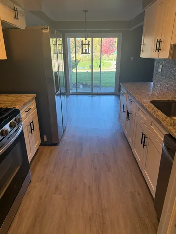 a kitchen with a wooden floor and a stove