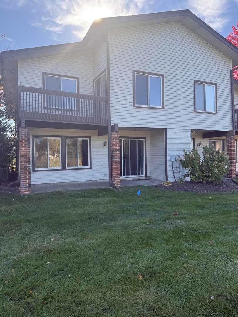 1319 Kingsbury Drive, Unit 2 Hanover Park, IL 60133 - Photo 20 of 44 a view of a house with a yard