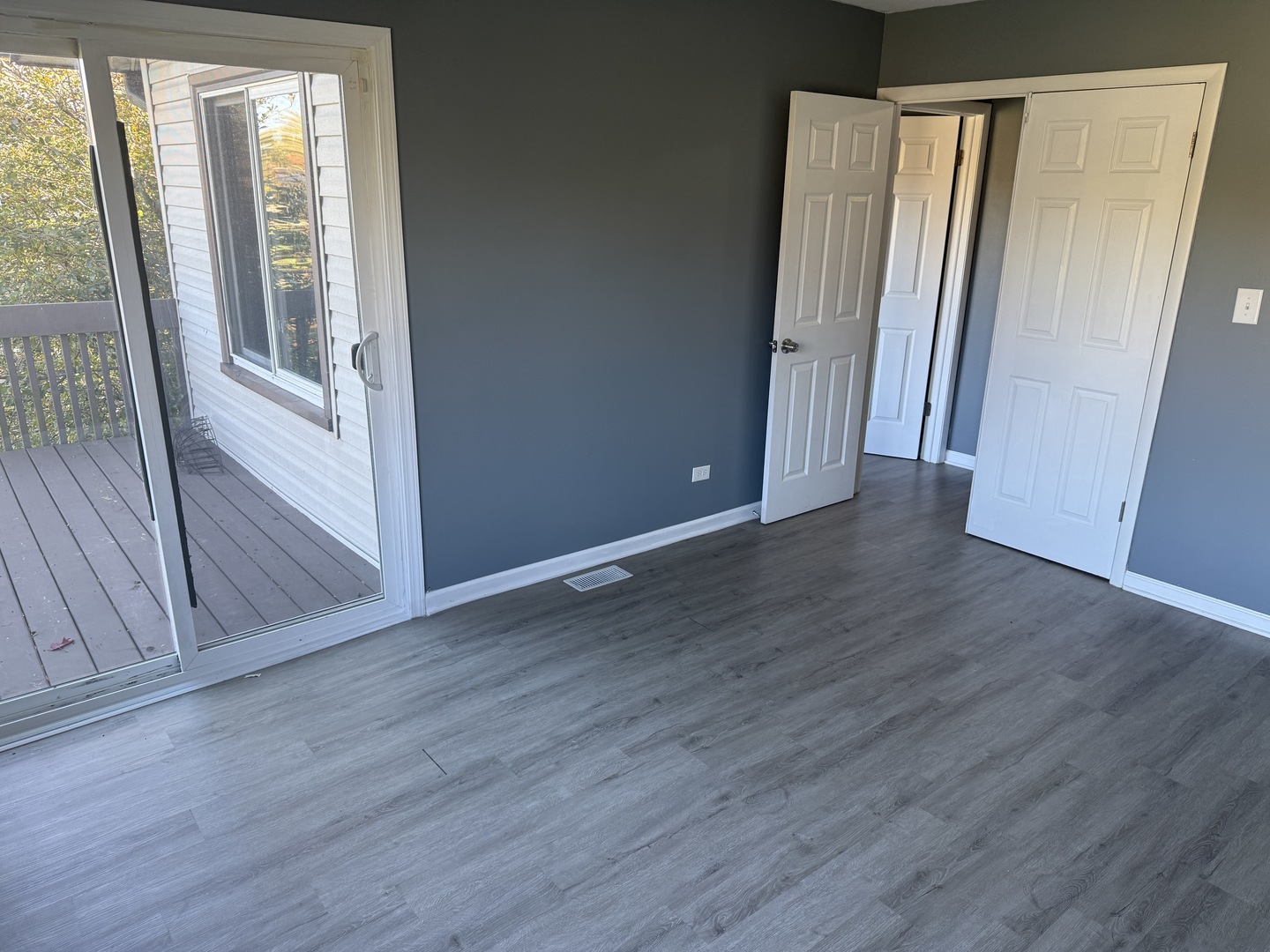 1319 Kingsbury Drive, Unit 2 Hanover Park, IL 60133 - Photo 41 of 44 an empty room with wooden floor and a window