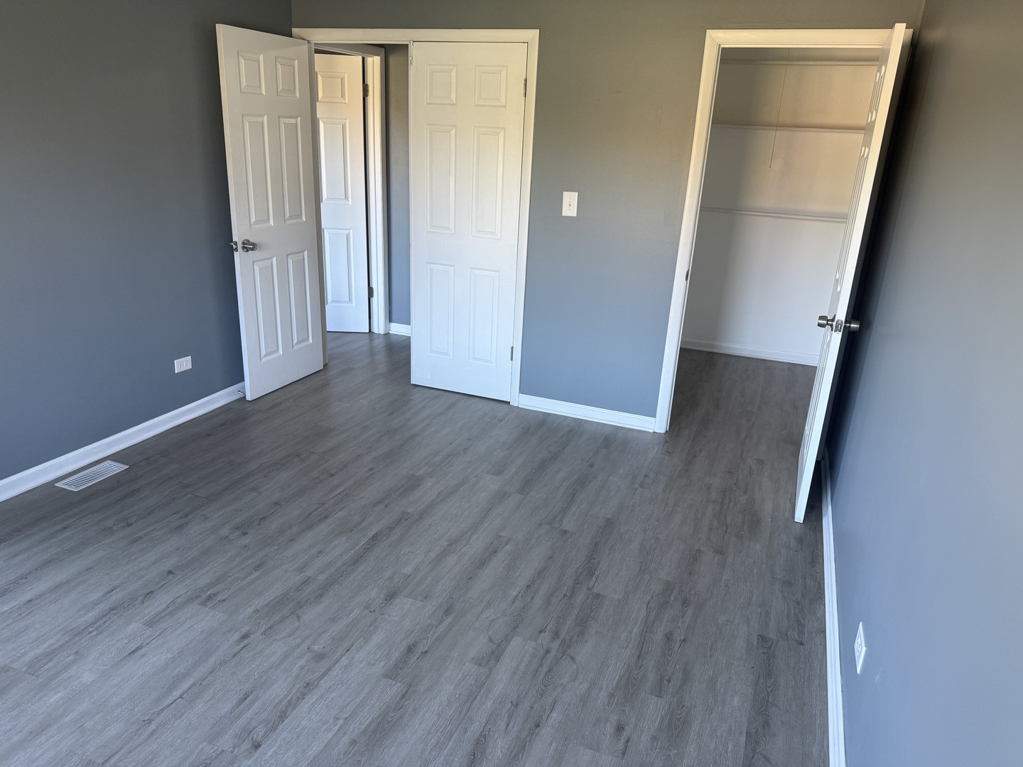 1319 Kingsbury Drive, Unit 2 Hanover Park, IL 60133 - Photo 42 of 44 an empty room with wooden floor and closet
