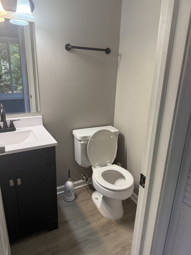 1319 Kingsbury Drive, Unit 2 Hanover Park, IL 60133 - Photo 44 of 44 a white toilet sitting next to a bathroom sink