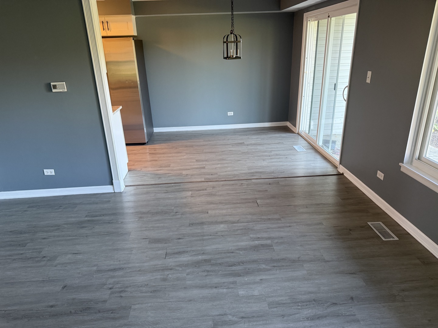 1319 Kingsbury Drive, Unit 2 Hanover Park, IL 60133 - Photo 8 of 44 wooden floor in an empty room with a window
