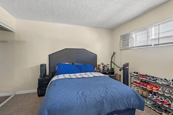 a bathroom with a sink a toilet a mirror and shower