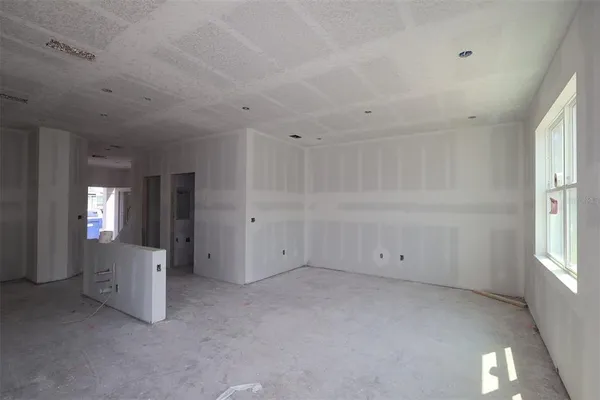 an empty room with windows and closet