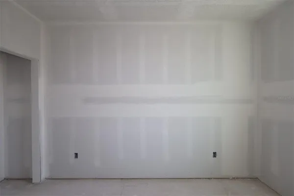 a view of an empty room and a window