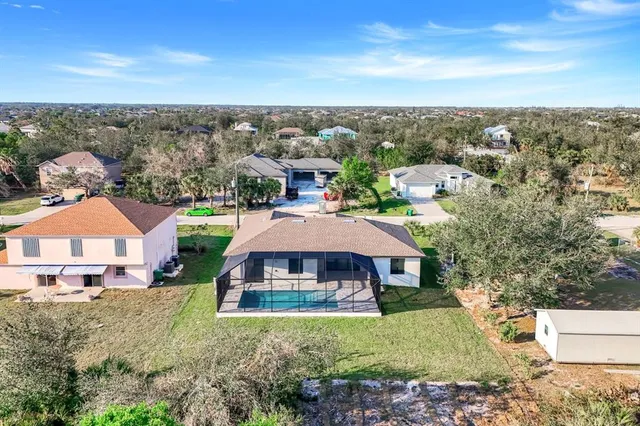 an aerial view of a house with a yard