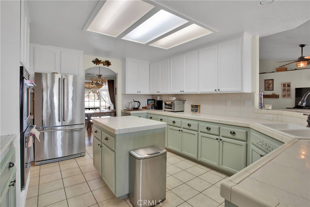 7330 Smoke Tree Road Phelan, CA 92371 - Photo 19 of 46 a kitchen with a sink appliances and cabinets