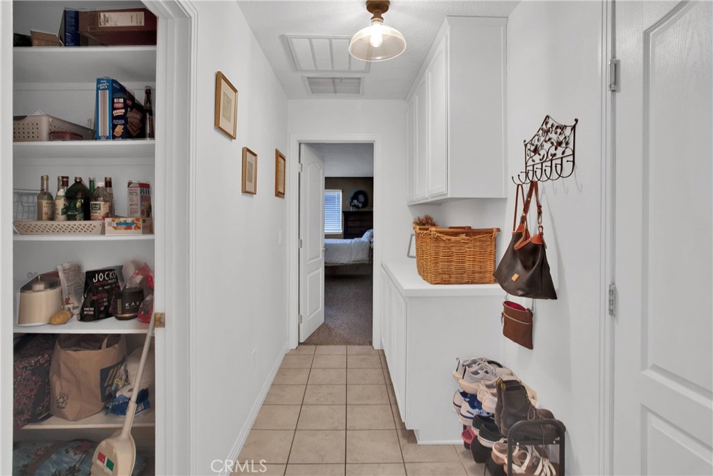 7330 Smoke Tree Road Phelan, CA 92371 - Photo 21 of 46 a hallway with white cabinets and wooden floor