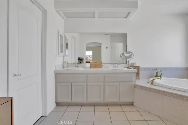 a bathroom with a sink vanity and mirror