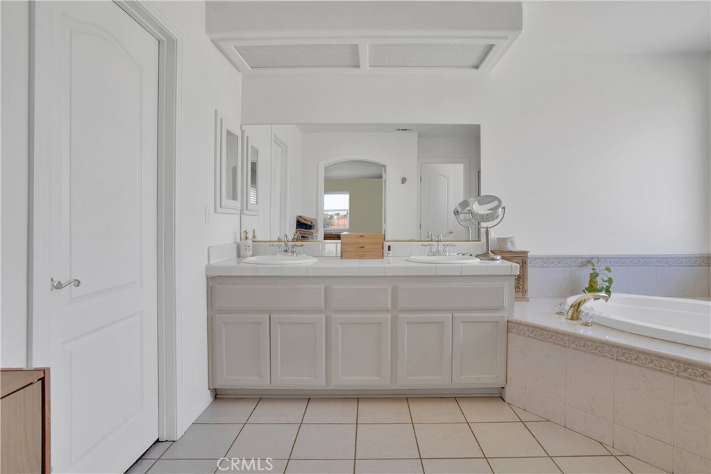 7330 Smoke Tree Road Phelan, CA 92371 - Photo 25 of 46 a bathroom with a sink vanity and mirror