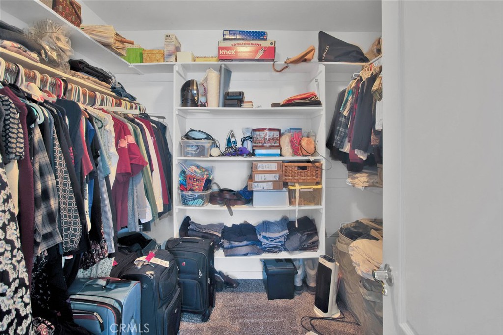 7330 Smoke Tree Road Phelan, CA 92371 - Photo 27 of 46 a view of walk in closet with clothes and shoes