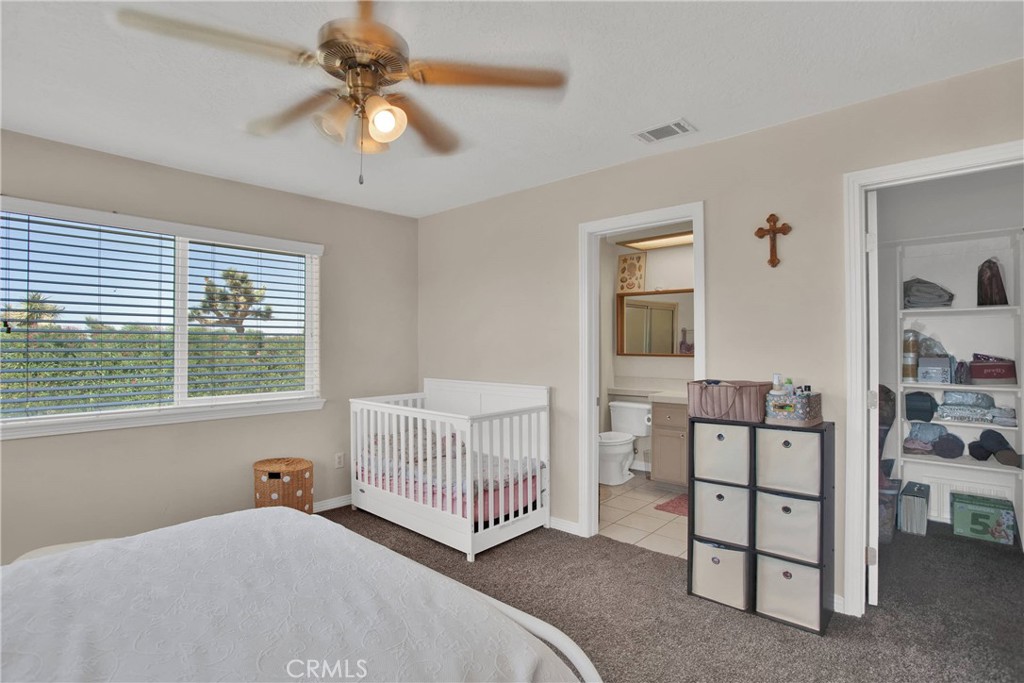 7330 Smoke Tree Road Phelan, CA 92371 - Photo 31 of 46 a bedroom with a bed and a window