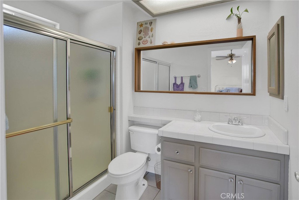 7330 Smoke Tree Road Phelan, CA 92371 - Photo 32 of 46 a bathroom with a sink toilet and mirror