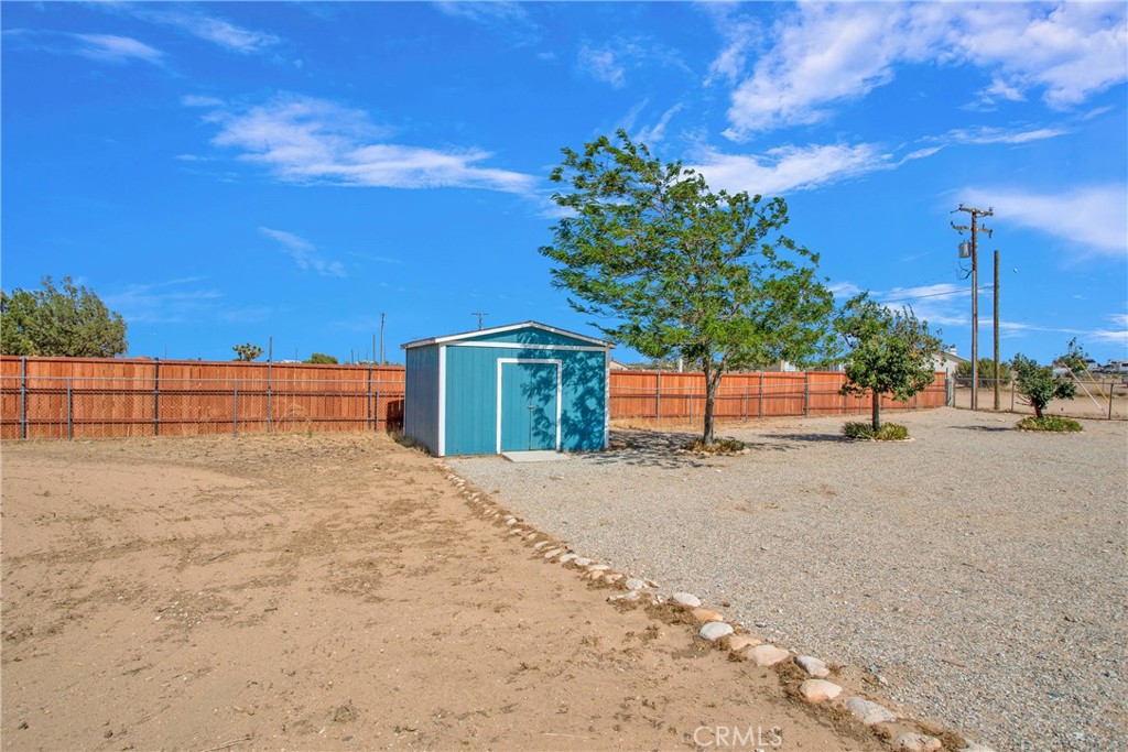 7330 Smoke Tree Road Phelan, CA 92371 - Photo 34 of 46 a street view with large building and mountain view in back