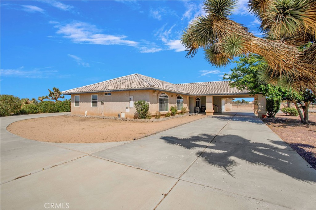 7330 Smoke Tree Road Phelan, CA 92371 - Photo 5 of 46 a white house with palm tree in front of it