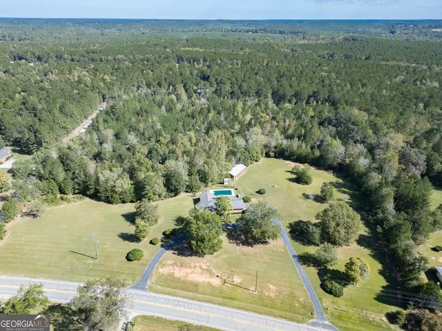 an aerial view of a house with a yard