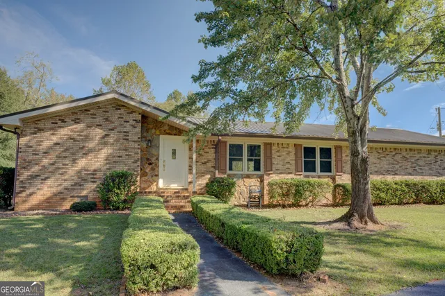 a front view of a house with garden