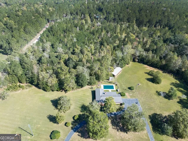 an aerial view of a house with a yard