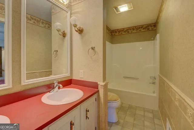a bathroom with a sink toilet tub and shower
