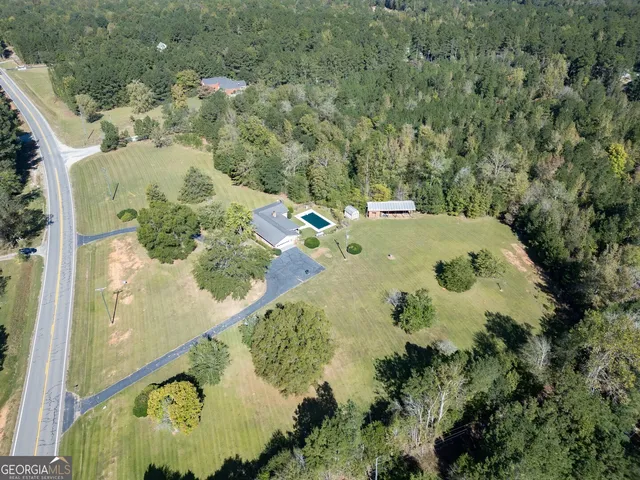 an aerial view of a residential houses with outdoor space