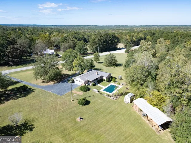 an aerial view of a house with a yard