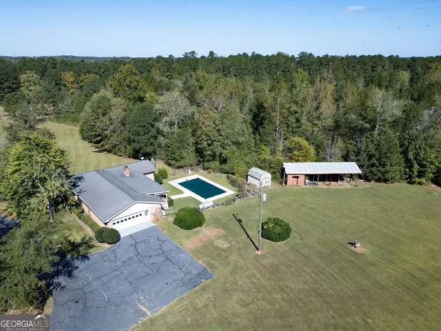 an aerial view of a house with yard
