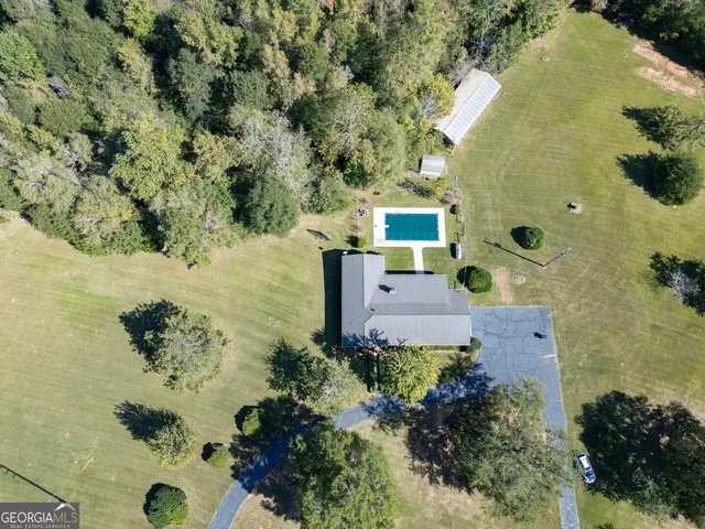 an aerial view of a house with a yard