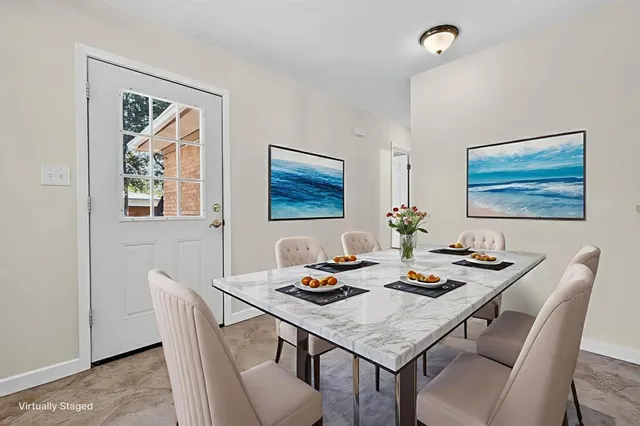 a view of a kitchen with furniture and a ceiling fan