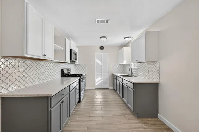 a bathroom with a tub a sink and mirror