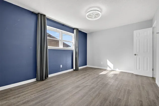 a bedroom with bed and a window