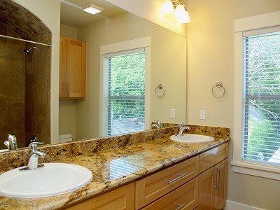 304 Zennia Street Austin, TX 78751 - Photo 13 of 26 a bathroom with a granite countertop sink and a mirror
