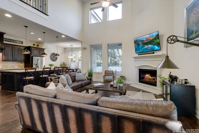a living room with furniture a fireplace and a flat screen tv