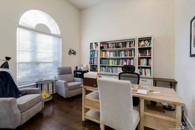 a living room with furniture and a book shelf