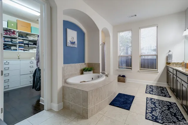 a bathroom with a sink a mirror and a bathtub