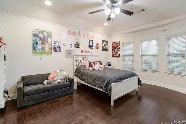 a spacious bedroom with a bed and a couch