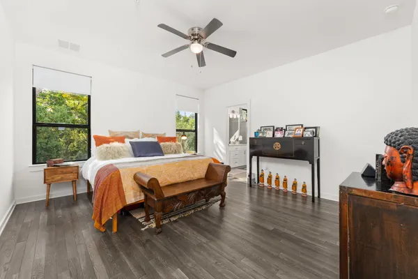 a bedroom with a bed and wooden floor
