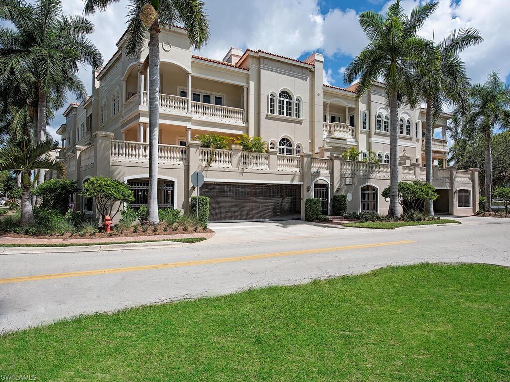 627 6th Avenue South, Unit B302 Naples, FL 34102 - Photo 14 of 14 a front view of a building with a garden and plants