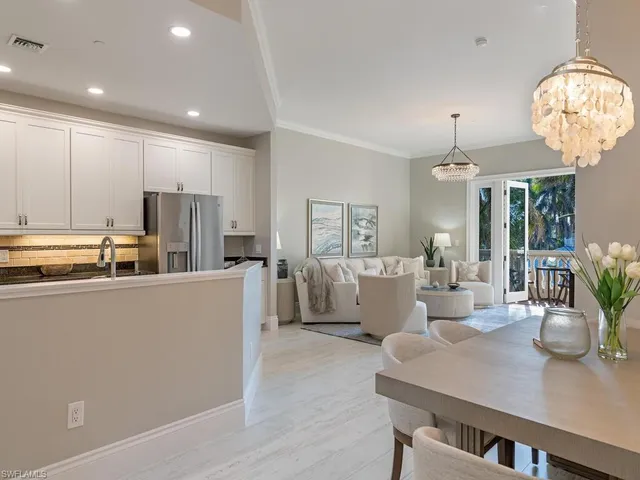 a living room with kitchen island furniture and a chandelier
