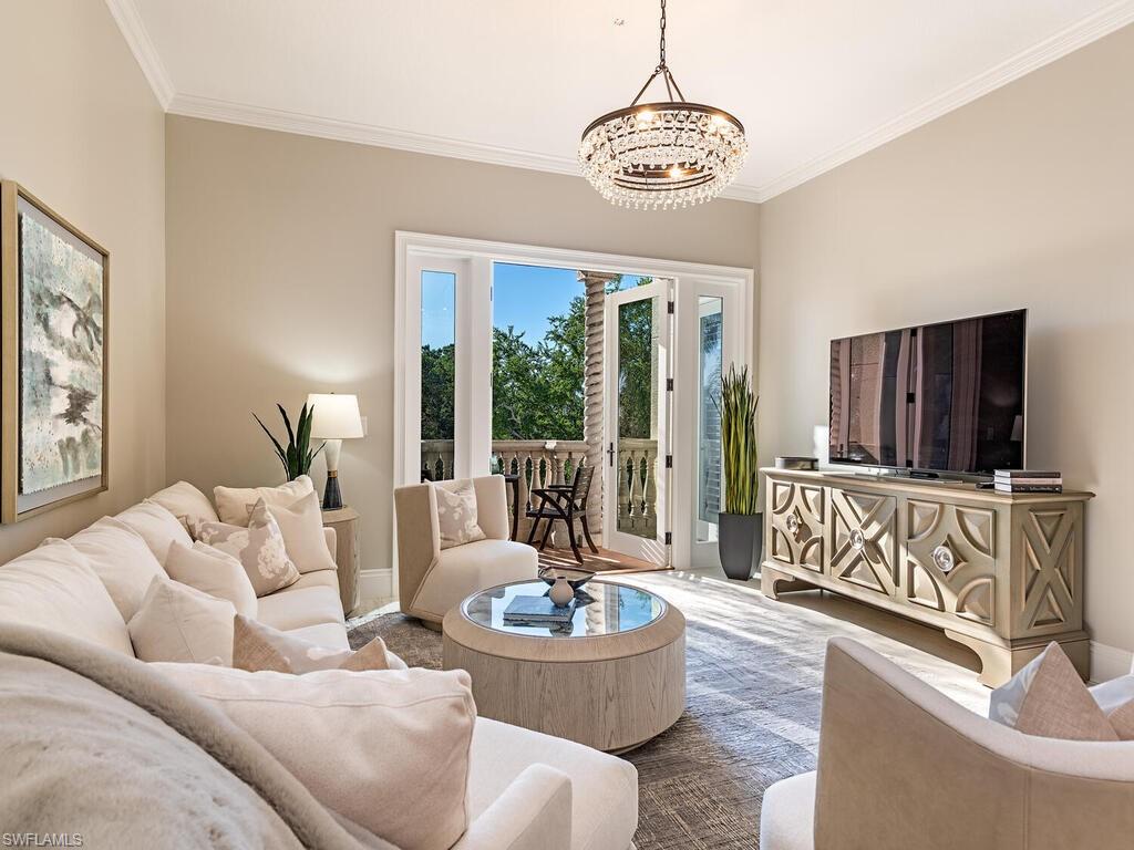 627 6th Avenue South, Unit B302 Naples, FL 34102 - Photo 5 of 14 a living room with furniture and a large window